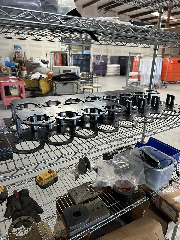 Wire shelves stacked with cut steel parts