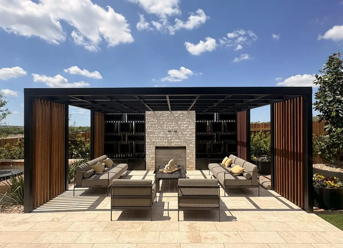 Steel pergola with wood slat walls over an outdoor lounge