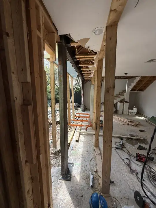 Steel column set between wood framing in a home remodel