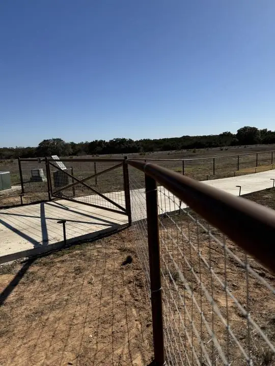 Pipe rail fence and walk gate at the entry