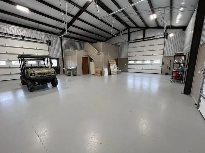 Shop interior with overhead doors and stair loft