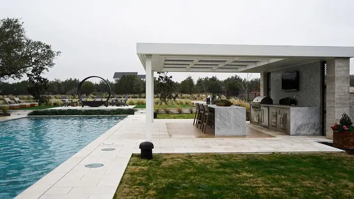 Poolside pergola over a full outdoor kitchen
