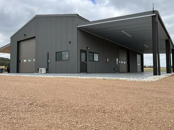 Gray steel shop with a full-length covered bay
