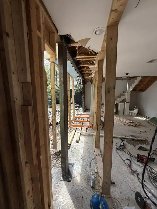 Steel column set between wood framing in a remodel